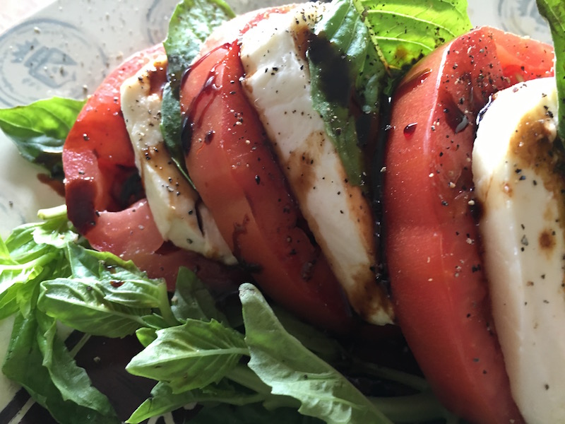 This classic Caprese Salad recipe combines the unbeatable combination of fresh basil, mozzarella and tomatoes and tops them off with a delicious balsamic glaze. #capresesalad #saladrecipes #basil